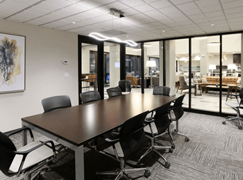 A conference room with a long table and chairs.